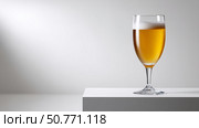 Refreshing golden beer served in a tall glass on a minimalist surface. Стоковое AI-изображение, AI-художник Katsiaryna Repich / Фотобанк Лори