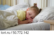 Peaceful adorable baby sleeping on a bed at home. Slumbering little child. Two years old girl sleeps peaceful at domestic room interior background. Serene dream. Cute face close up. Deep kid slumber. Стоковое видео, видеограф Марина Демидюк / Фотобанк Лори