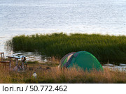 Wild tourism. Summer overnight stay by the water. Tent on a picturesque river bank at sunset. Стоковое фото, фотограф Роман Дзюбало / Фотобанк Лори