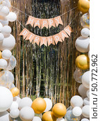 "Happy Birthday" inscription on the photo zone of balloons and foil rain, festive location. Birthday decorations - balloons and garland for children's party. Стоковое фото, фотограф Photojuli / Фотобанк Лори