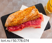 Burger with ham served on a service board with juice. Стоковое фото, фотограф Яков Филимонов / Фотобанк Лори