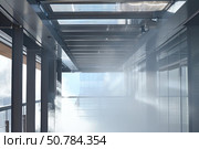 Fire sprinkler system activating in a modern office building. Стоковое AI-изображение, AI-художник Иван Рябоконь / Фотобанк Лори