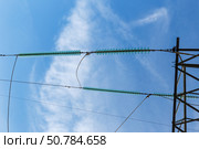 Electrical insulators on power transmission lines against a blue sky. Стоковое фото, фотограф Михаил Пряхин / Фотобанк Лори
