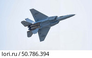 Military aircraft performing an aerial maneuver against blue sky. Стоковое AI-изображение, AI-художник Ольга Невская / Фотобанк Лори