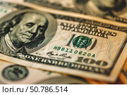 Close up of one hundred dollar bills showing benjamin franklin portrait. Стоковое AI-изображение, AI-художник Иван Рябоконь / Фотобанк Лори