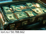 Briefcase full of one hundred dollar bills brimming with cash. Стоковое AI-изображение, AI-художник Иван Рябоконь / Фотобанк Лори