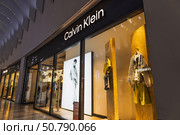 Calvin Klein Storefront with Illuminated Logo. London, UK, 27 May 2024. Редакционное фото, фотограф Zydrius Tartenis / Фотобанк Лори
