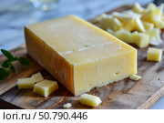 Block of comte cheese with sliced pieces on wooden cutting board. Стоковое AI-изображение, AI-художник Иван Рябоконь / Фотобанк Лори