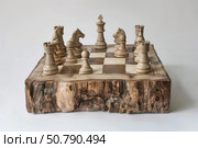 Wooden chess pieces standing on rustic wooden chessboard. Стоковое AI-изображение, AI-художник Иван Рябоконь / Фотобанк Лори