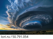 Supercell storm cloud forming over plains at sunset. Стоковое AI-изображение, AI-художник Иван Рябоконь / Фотобанк Лори