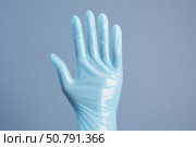 Blue nitrile glove making stop sign, representing hygiene and protection. Стоковое AI-изображение, AI-художник Иван Рябоконь / Фотобанк Лори