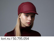 Fashion model wearing stylish red burgundy visor cap and turtleneck. Стоковое AI-изображение, AI-художник Иван Рябоконь / Фотобанк Лори