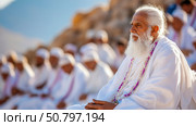Contemplative Elder in White Garments Amidst a Congregation. Стоковое AI-изображение, AI-художник Данила Большаков / Фотобанк Лори