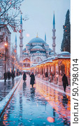 Snowy Scene at the Sultan Ahmed Mosque: Illuminated Pathway and Winter Wonderland. Стоковое AI-изображение, AI-художник Данила Большаков / Фотобанк Лори