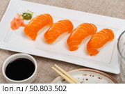 Sushi sake nigiri with salmon served on platter. Стоковое фото, фотограф Яков Филимонов / Фотобанк Лори