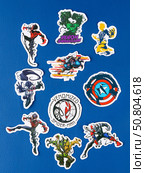 Novosibirsk, Russia - March 1, 2025: Cartoon-style vinyl stickers featuring Venom in various comic book situations on a bright blue background. Редакционное фото, фотограф Виталий Сова / Фотобанк Лори