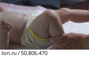 Slow-motion video of bicycle leg massage for an infant under one year to improve hip and knee joint mobility. Pediatric physiotherapy technique. Стоковое видео, видеограф Татьяна Степанищева / Фотобанк Лори