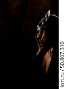 A man in a shirt holds his fingers on the sensual lips of a submissive lover. Portrait Woman in a leather cat mask. BDSM Games for adults. Стоковое фото, фотограф Михаил Решетников / Фотобанк Лори