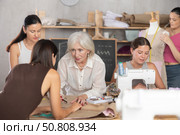 Fellow clothing designers collaborating on order in workshop. Стоковое фото, фотограф Яков Филимонов / Фотобанк Лори