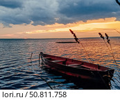 Wooden boat on tranquil water at sunset. Стоковое фото, фотограф Константин Григорьев / Фотобанк Лори