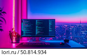 Cyberpunk coding setup: A neon-lit workspace overlooking the city skyline, showcasing a digital developer’s nightly environment. Стоковое AI-изображение, AI-художник Данила Большаков / Фотобанк Лори
