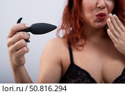 Excited woman in underwear holds a anal plug. Стоковое фото, фотограф Михаил Решетников / Фотобанк Лори