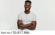 Smiling happy positive healthy African American black male smiling model wearing a blank white cotton short-sleeved t-shirt isolated on white studio background. Positive speech of young handsome man. Стоковое AI-видео, аниматор Sergey Grishin / Фотобанк Лори