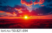 Concept: prairie sunrise, an awakening of light and shadow over a field of grass in bright reds and oranges, for print, card, poster. Стоковое AI-изображение, AI-художник Данила Большаков / Фотобанк Лори