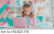 Girl immersed in learning with her pink portable computer. Стоковое AI-видео, аниматор Данила Большаков / Фотобанк Лори