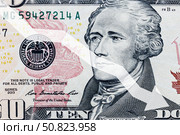 Arrow down on the background of dollar bill. The concept of inflation, depreciation of the dollar or the US economy. Стоковое фото, фотограф Емельянов Евгений Викторович / Фотобанк Лори