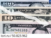 Arrow down on the background of dollar bills. The concept of inflation, depreciation of the dollar or the US economy. Стоковое фото, фотограф Емельянов Евгений Викторович / Фотобанк Лори