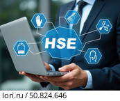 HSE Concept for Workplace Health and Safety. Businessman using laptop with icons representing health, safety, and environmental protection, illustrating HSE management system in business process. Стоковое AI-изображение, AI-художник Sergey Grishin / Фотобанк Лори
