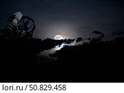 Telescope pointed out to the night sky with moon and clouds. Стоковое фото, фотограф Roth Ritter/Stocktrek Images / ТАСС / Фотобанк Лори