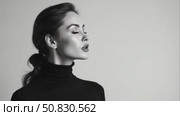 Black and white fashion art studio portrait of beautiful elegant woman in black turtleneck. Hair high beam, perfect profile face. Elegant beauty style. Стоковое AI-видео, аниматор Sergey Grishin / Фотобанк Лори