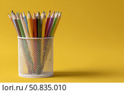 Close-Up of Vibrant Colorful Pencils in a pen holder isolated on yellow background. Banner, copy space. Colourful sharpened colored pencils for art projects, drawing, and creativity. Back to school. Стоковое AI-изображение, AI-художник Марина Демидюк / Фотобанк Лори