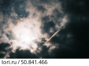 Jet leaves contrail through dark dramatic clouds at high altitude. Captures speed, aviation, and the powerful energy of travel and atmosphere. Стоковое AI-изображение, AI-художник Александра Троицкая / Фотобанк Лори