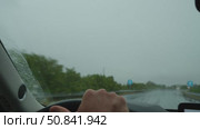 Driver navigating highway in heavy rain with active wipers. Стоковое видео, видеограф Данил Руденко / Фотобанк Лори
