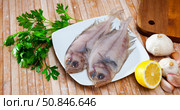 Two whole fresh megrims with seasonings. Стоковое фото, фотограф Яков Филимонов / Фотобанк Лори