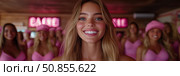 Pink Posse: A portrait of a woman with a beaming smile surrounded by women wearing pink clothing. Стоковое AI-изображение, AI-художник Данила Большаков / Фотобанк Лори