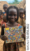 Empowerment through education: a cheerful girl holds her book, a symbol of learning and a brighter future. Стоковое AI-изображение, AI-художник Данила Большаков / Фотобанк Лори