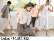 Young girl practicing hip hop slide moves in training hall. Стоковое фото, фотограф Яков Филимонов / Фотобанк Лори