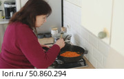 Senior active woman cooking lunch at home in modern kitchen. Healthy eating, food and culinary concept. Hands of old lady with knife chopping vegetables, grating carrots. Elderly female cook a soup. Стоковое видео, видеограф Марина Демидюк / Фотобанк Лори