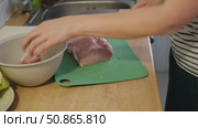 Female butcher cut raw meat with sharp knife at home kitchen. Woman cutting the chicken fillet in pieces for cooking. Preparing chopping food. Split poultry breast. Healthy lean meat, low cholesterol. Стоковое видео, видеограф Марина Демидюк / Фотобанк Лори