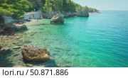 People enjoy turquoise waters and rocky coastline of Makarska cove in Croatia. Стоковое видео, видеограф Igor Tichonow / Фотобанк Лори