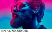 Vaporwave Portrait: A bearded man gazes upward, bathed in neon hues of pink and blue, showcasing contemplative masculinity. Стоковое AI-изображение, AI-художник Данила Большаков / Фотобанк Лори