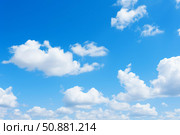 Bright blue sky with fluffy white clouds creating serene atmosphere. Стоковое AI-изображение, AI-художник Иван Рябоконь / Фотобанк Лори