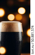 Glass goblet with fresh dark beer, guinness or stout close-up. Стоковое AI-изображение, AI-художник Екатерина Селезнева / Фотобанк Лори