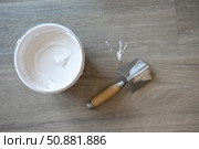 The spatula for the corners and the jar with putty. Laminated grey background. Repair concept, repair goods stores. Top down view. Copy space. Стоковое фото, фотограф Екатерина Топорова / Фотобанк Лори