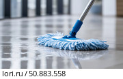 Cleaning process in a modern interior with a blue mop on the floor. Стоковое AI-изображение, AI-художник Katsiaryna Repich / Фотобанк Лори