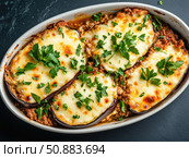 Moussaka with layers of eggplant, ground lamb, and bechamel sauce. Стоковое AI-изображение, AI-художник Татьяна  Бральнина / Фотобанк Лори